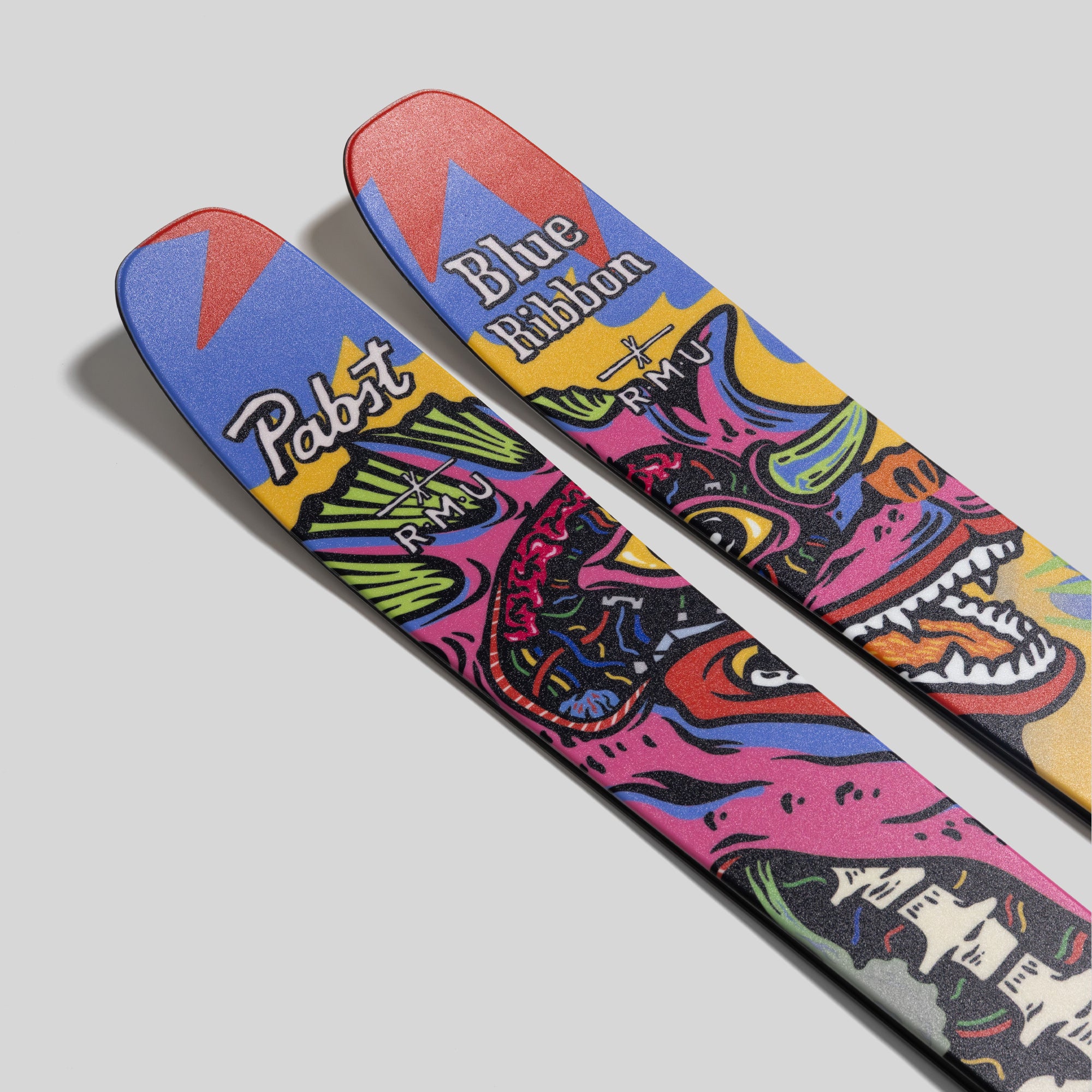 Colorful skateboard with graphic design and brand names on a light gray background